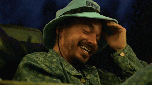 Man in Blue Hat Saying Guns