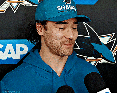 Man in Blue Hat Saying Sharks Hockey
