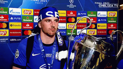 Man In Blue Headband Holding Trophy GIF