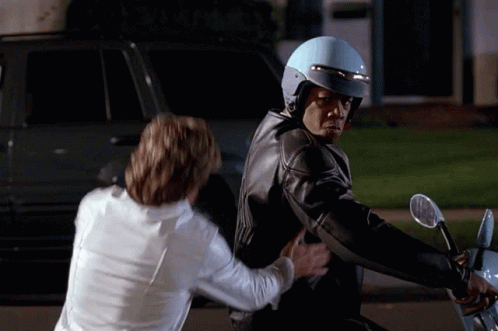 Man in Blue Helmet Being Pushed