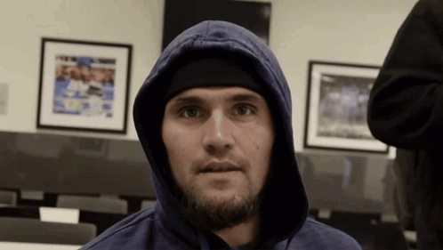 Man In Blue Hoodie And Black Headband Looking At Camera GIF