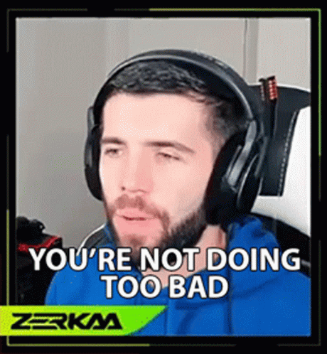 Man in Blue Hoodie and Headphones Sitting in Chair