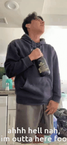 Man in Blue Hoodie Holding Corona Bottle