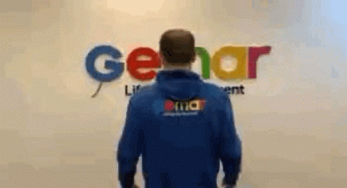 Man in Blue Hoodie in Front of Gerar Sign