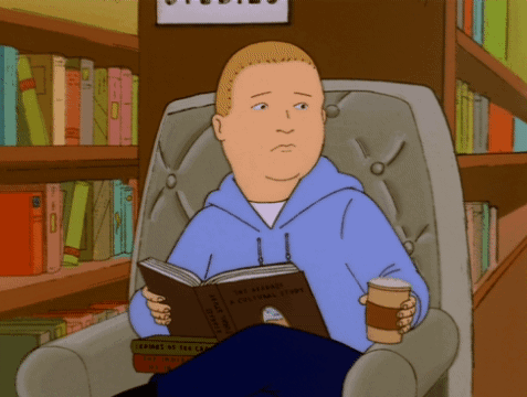 Man in Blue Hoodie Reading Bible