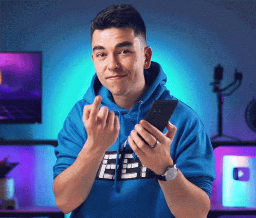 Man in Blue Hoodie with F Holding Phone
