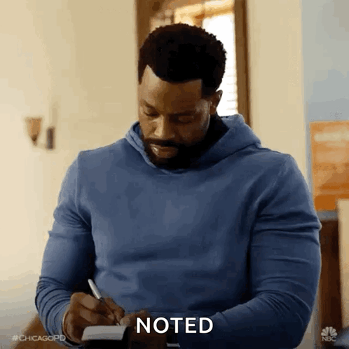 Man in Blue Hoodie Writing