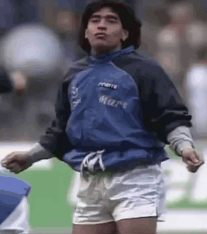Man in Blue Jacket and Shorts on Soccer Field