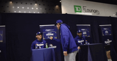 Man in Blue Jacket at TD Lounge Sign
