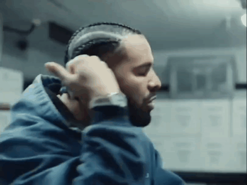 Man in Blue Jacket Braiding Hair