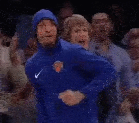 Man in Blue Jacket Dancing in Crowd