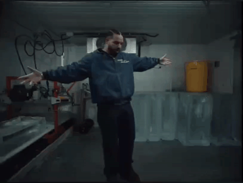 Man in Blue Jacket Dancing with Ice Blocks