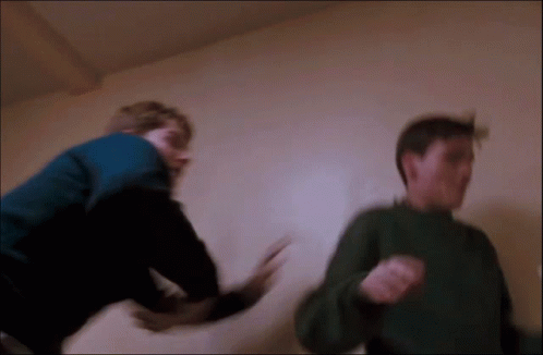 Man in Blue Jacket Fighting Another