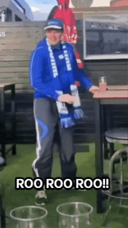 Man in Blue Jacket Holding Bottle Saying Roo Roo Roo