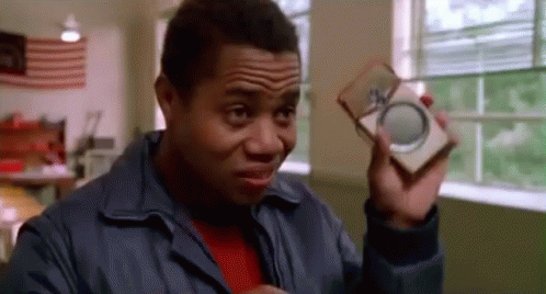 Man in Blue Jacket Holding Box and Magnifying Glass