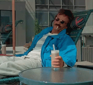 Man in Blue Jacket Holding Drink