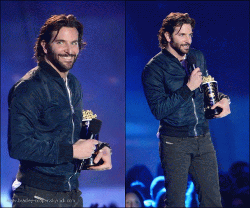 Man in Blue Jacket Holding Trophy and Microphone