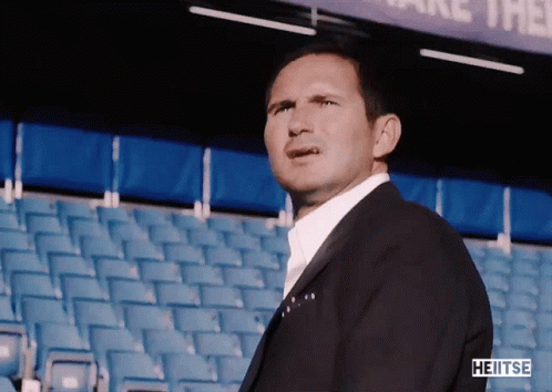 Man In Blue Jacket In Front Of Etihad Airways Banner GIF