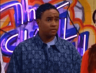 Man In Blue Jacket In Front Of Neon Sign Saying Chill GIF