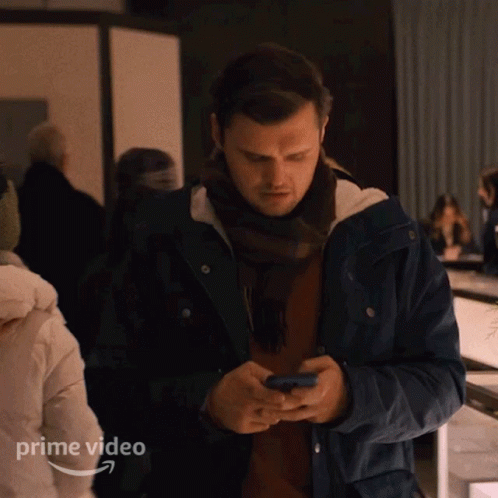Man in Blue Jacket Looking at Phone Prime Video