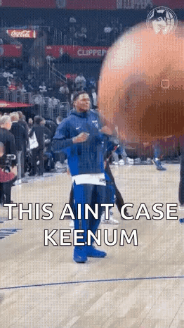 Man in Blue Jacket on Basketball Court