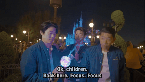 Man In Blue Jacket Says Ok Children Back Here Focus Focus In Front Of Castle GIF