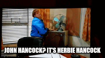 Man In Blue Jacket Sits In Front Of Fan Caption John Hancock It's Herbie Hancock GIF