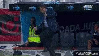 Man in Blue Jacket Standing Before Cada Jue Sign