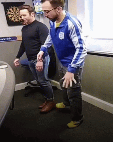 Man in Blue Jacket with England Next to Another Man