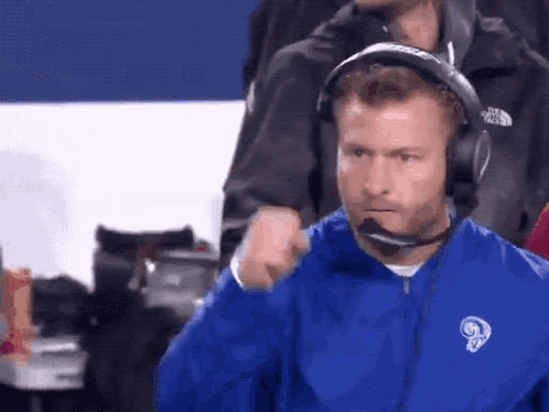 Man in Blue Jacket With Ram and Headphones