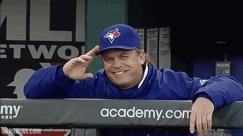 Man In Blue Jays Hat Leaning Over Fence GIF