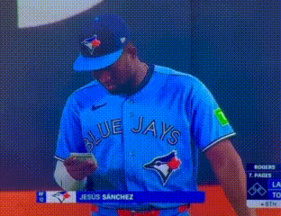 Man in Blue Jays Jersey Looking at Phone