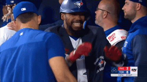 Man in Blue Jays Jersey Surrounded