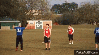 Man in Blue Jersey 32 Throws Frisbee