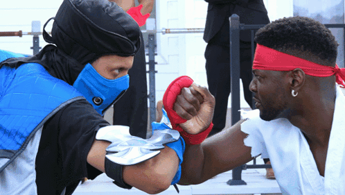 Man In Blue Mask And Red Headband Fist Bump GIF
