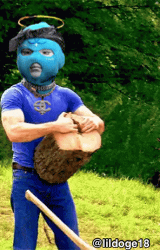 Man in Blue Mask Holding Log and Shovel