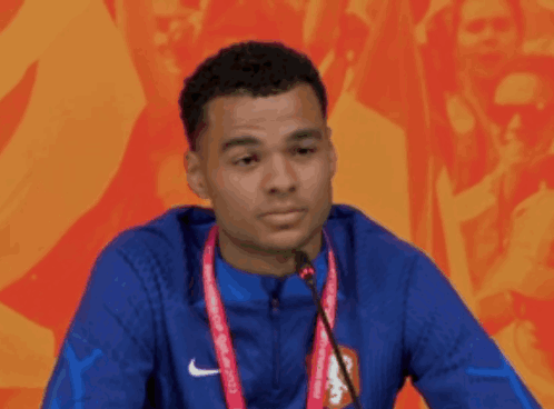 Man in Blue Nike Jacket Speaking