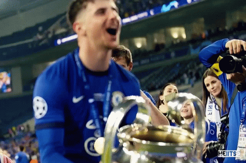 Man in Blue Nike Jersey Holding Trophy