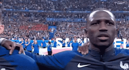 Man in Blue Nike Shirt in Front of Crowd