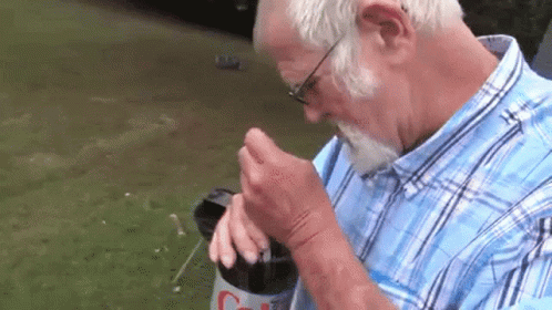 Man in Blue Plaid Shirt Drinking Diet Coke