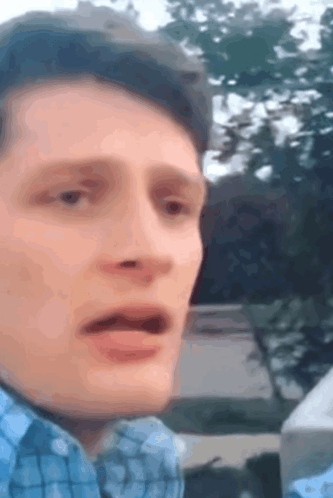 Man in Blue Plaid Shirt Making Funny Face