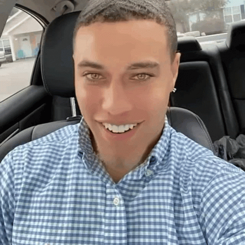 Man in Blue Plaid Shirt Smiling in Car