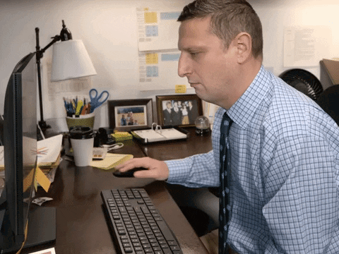 Man in Blue Plaid Shirt Using Keyboard
