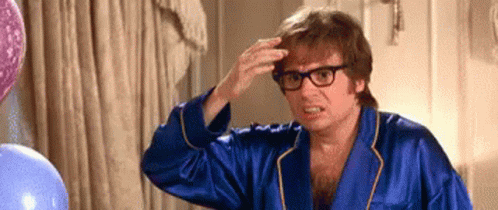 Man in Blue Robe and Glasses Touching Hair
