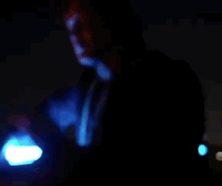 Man in Blue Robe Holding Blue Light