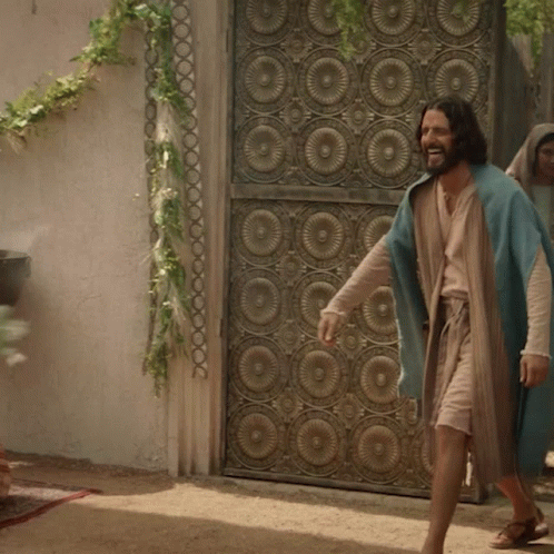 Man in Blue Robe in Front of Wrought Iron Door