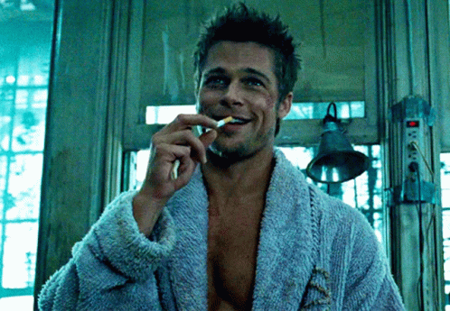 Man In Blue Robe Smoking Cigarette And Smiling GIF