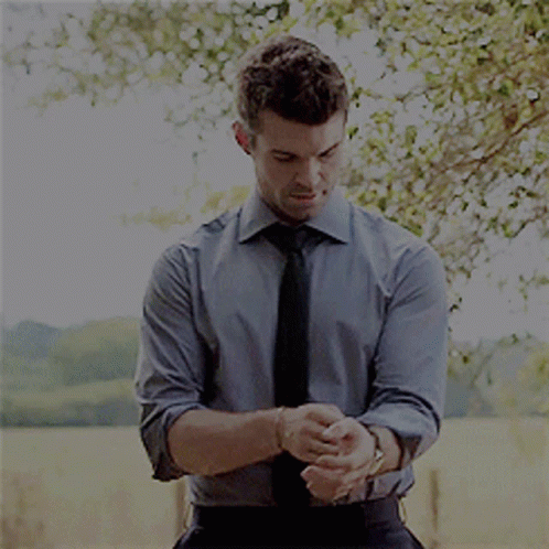 Man In Blue Shirt And Black Tie Adjusting Cufflinks GIF