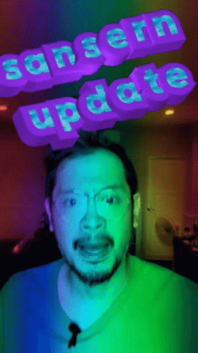 Man in Blue Shirt and Glasses with Sanserin Update Sign