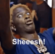Man In Blue Shirt And Necklace Making Funny Face Saying Sheeesh GIF